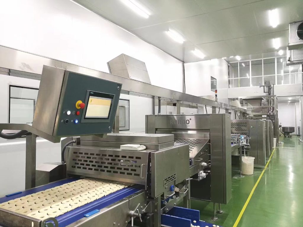 Food forming and conveying equipment inside a food-processing workshop in Jiangsu, China